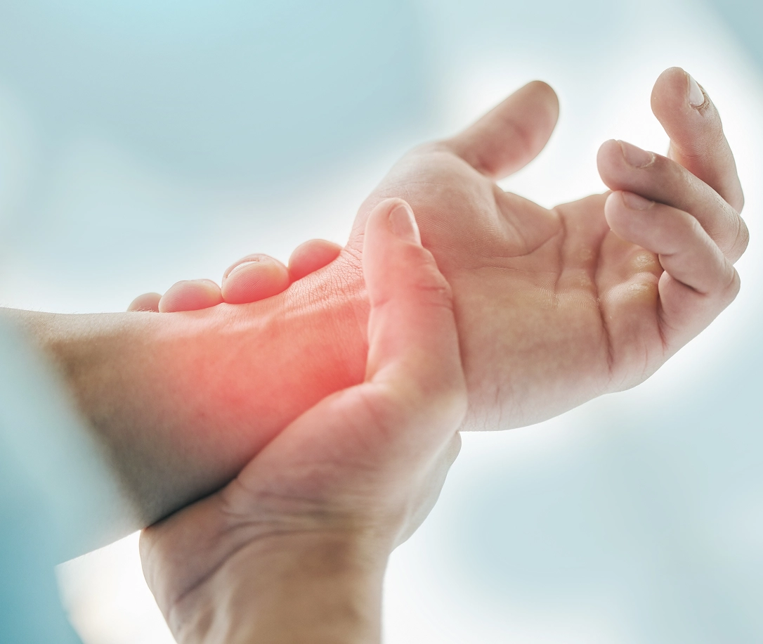 hand highlighted red to show pain, orthopedic wrist treament and surgery