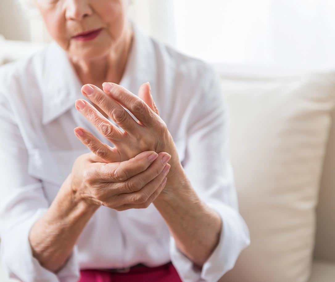 Older woman grabbing hand in pain
