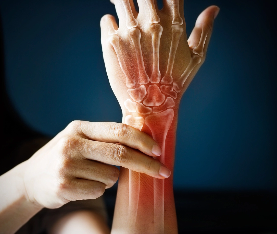 Person grabbing their wrist in pain