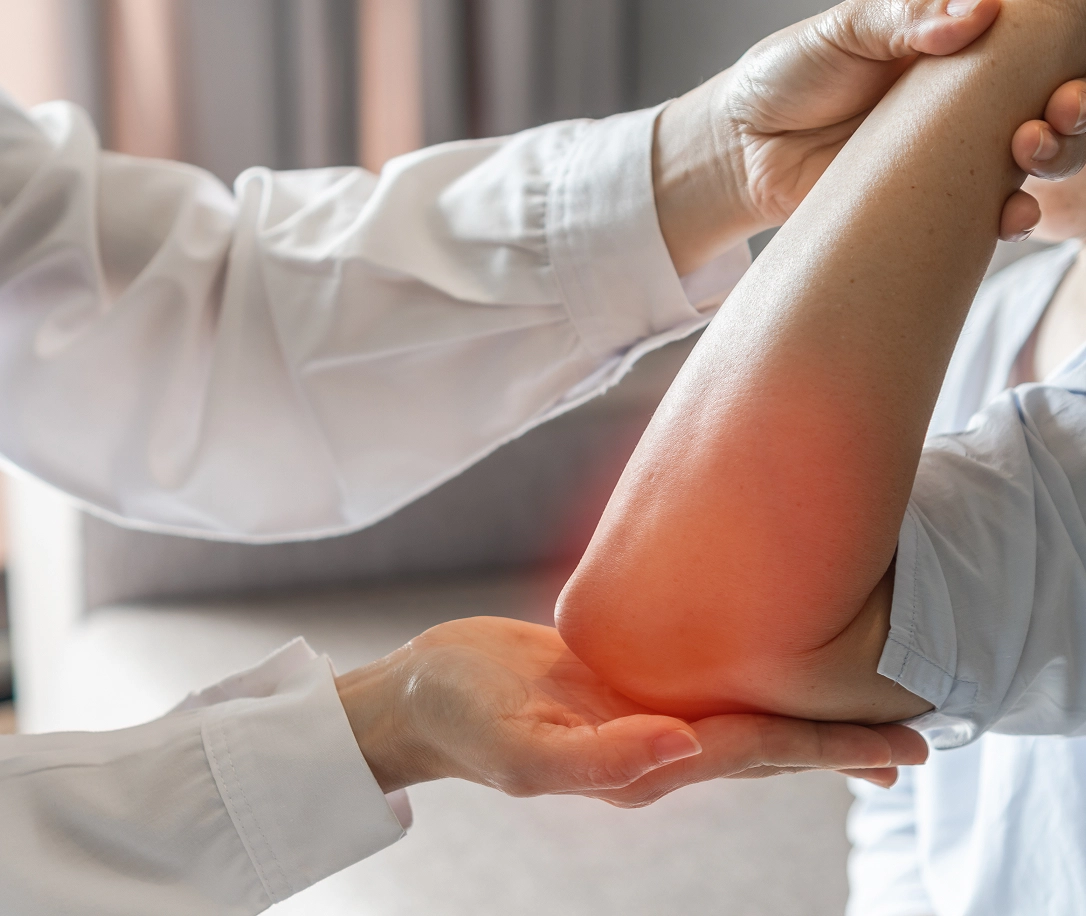 Doctor bending patient's elbow, orthopedic elbow treament and surgery