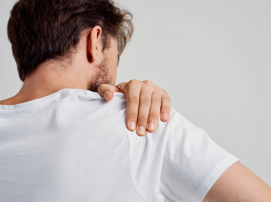 Man holding his shoulder - Friendswood, TX Orthopaedic Hand, Wrist & Elbow Surgery