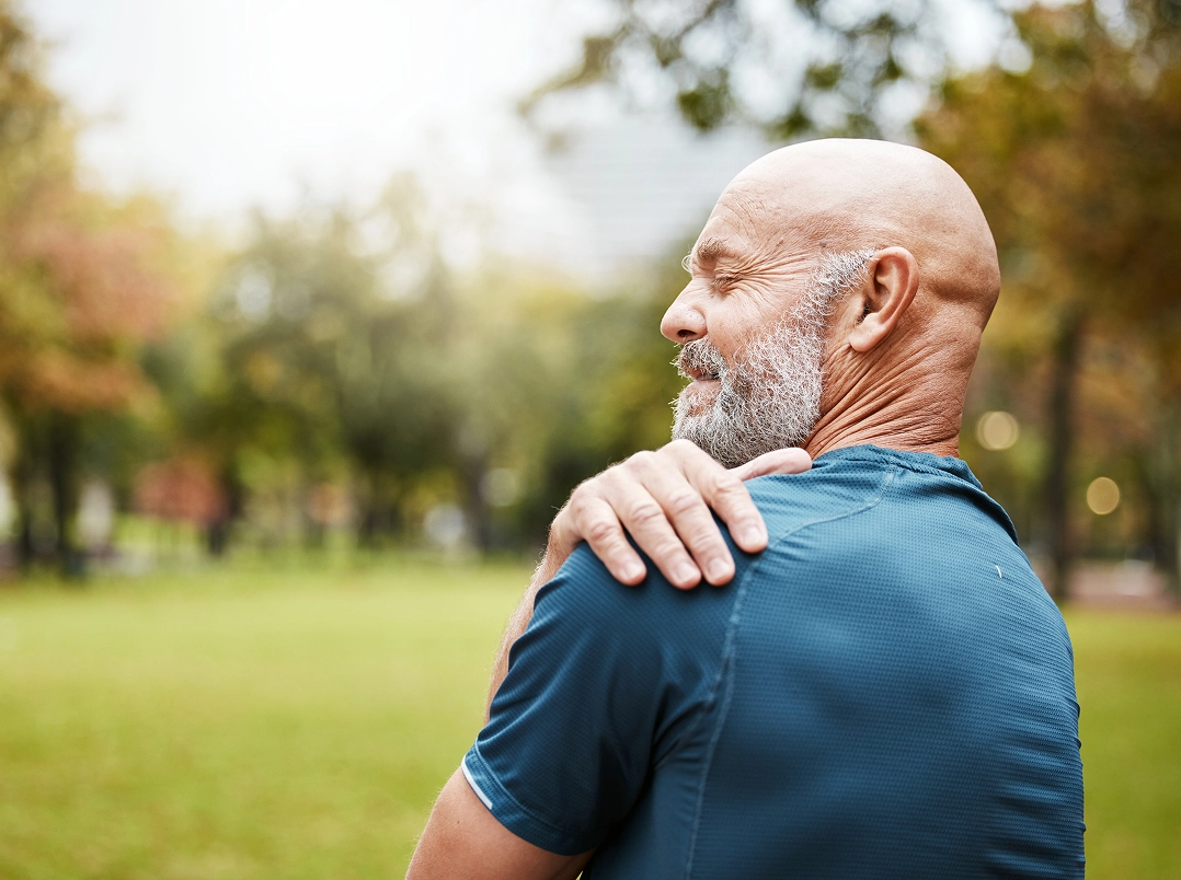 Older man holding his shoulder - Kingwood, TX Orthopaedic Hand, Wrist & Elbow Surgery