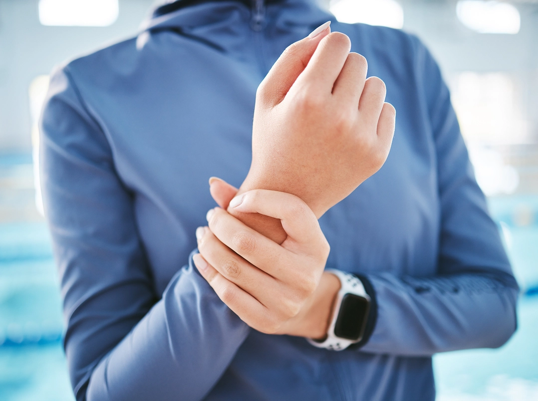 person holding their wrist - League City, TX Orthopaedic Hand, Wrist & Elbow Surgery