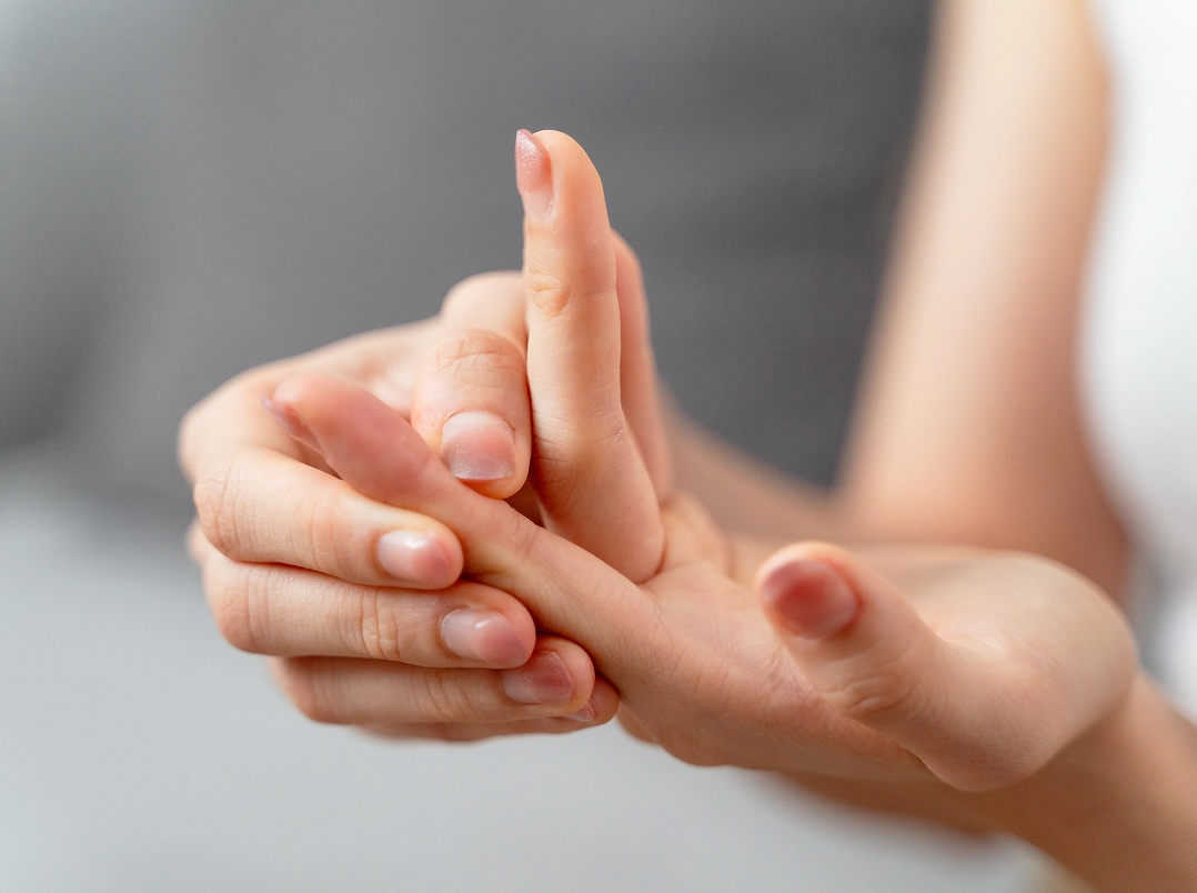 someone holding their finger - Missouri City, TX Orthopaedic Hand, Wrist & Elbow Surgery