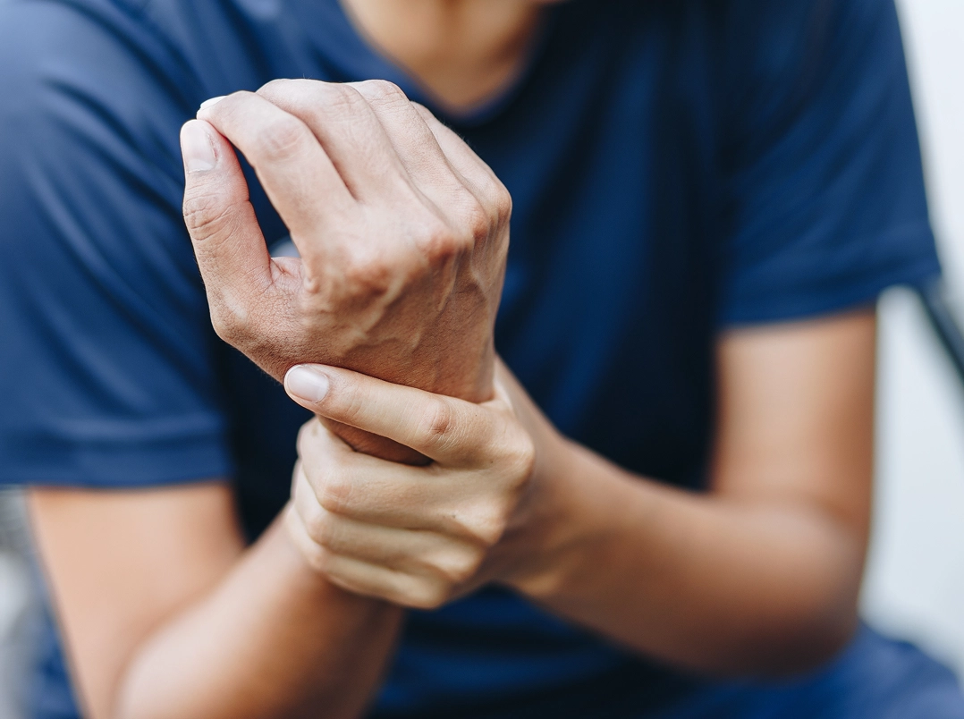 person holding their wrist - Pasadena, TX Orthopaedic Hand, Wrist & Elbow Surgery