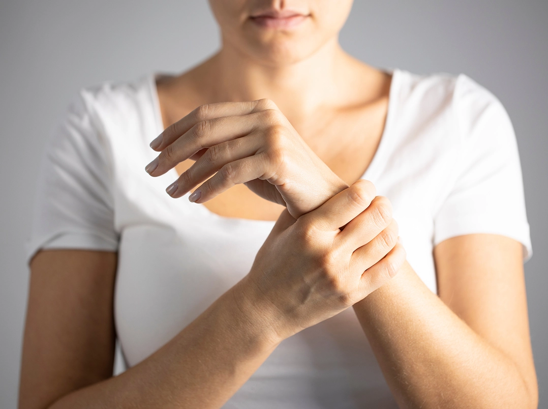 woman holding her wrist - Sugar Land, TX Orthopaedic Hand, Wrist & Elbow Surgery