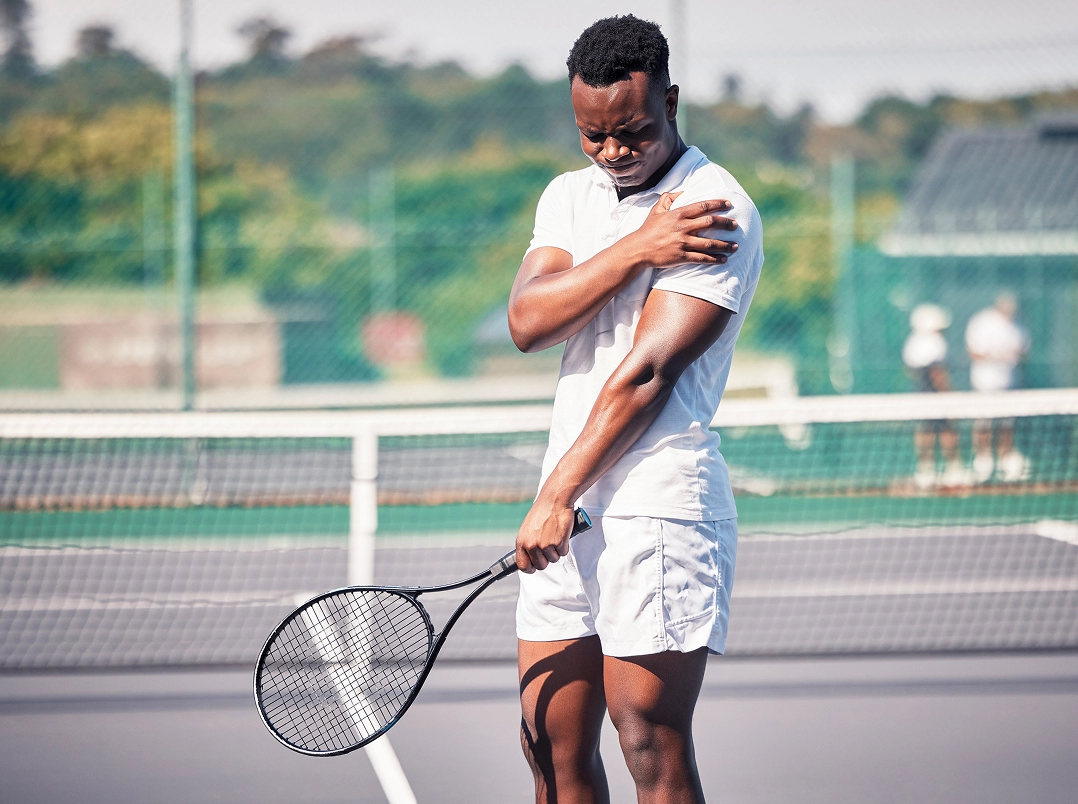 Tennis player holding his shoulder - Willowbrook, TX Orthopaedic Hand, Wrist & Elbow Surgery